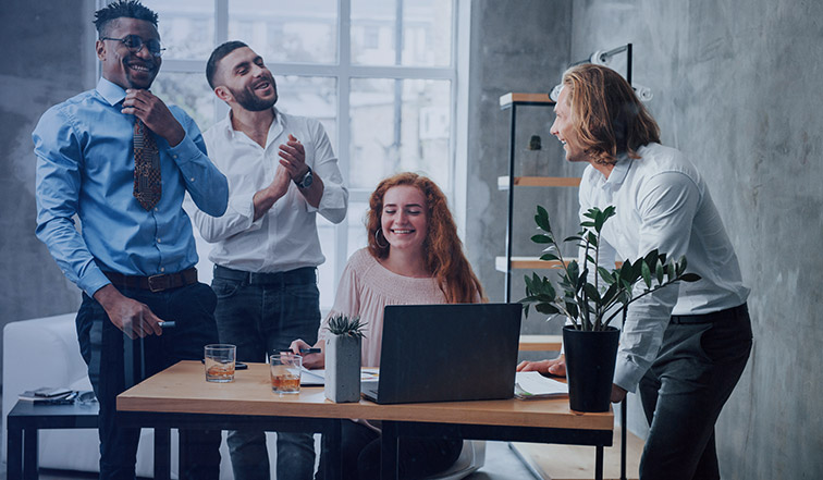 business professionals around a laptop